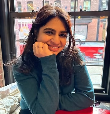 Portrait of Aditi Chawla, a friendly and warm therapist in her office